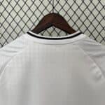 Authentic white football jersey with black collar, close-up of fabric texture and stitching.