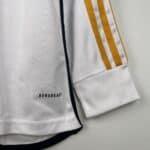 Athletic sports jersey featuring "AEROREADY" branding, white with gold stripes and black trim for ac.