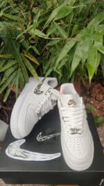 Air Force Low 1 ‘Molten Metal’ sneakers with metallic accents and white design.
