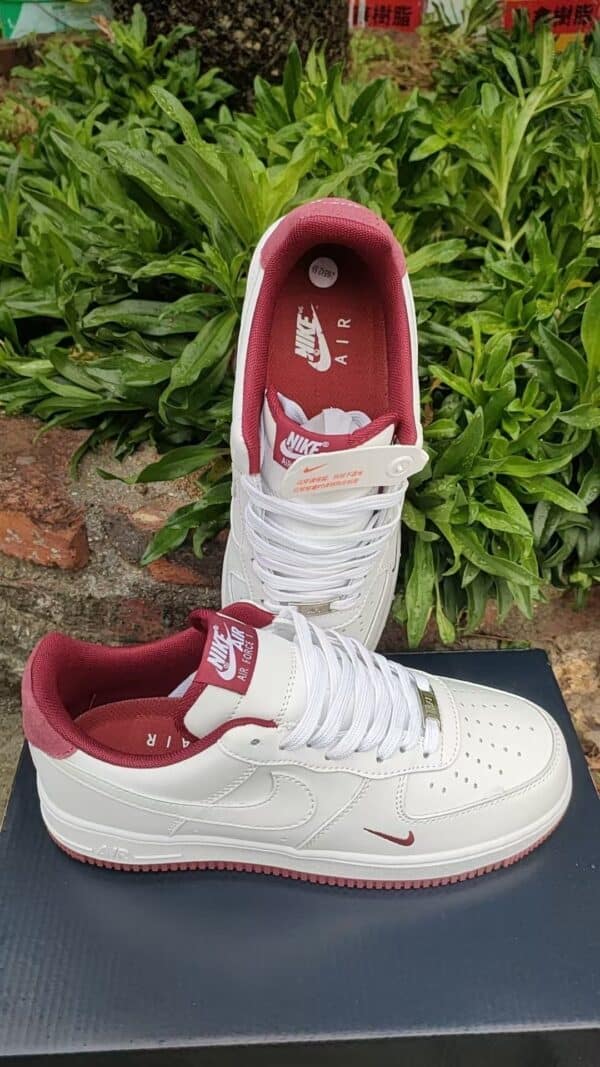 Nike Air Force Low 1 sneakers in white and red, stylish and comfortable for sports and casual wear.