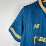Blue Porto away football jersey 2023/24 with gold accents and New Balance logo.