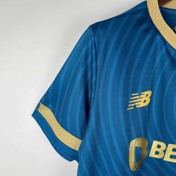Blue Porto away football jersey 2023/24 with gold accents and New Balance logo.