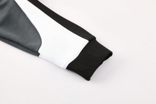 Close-up of Nike Dri-fit jacket sleeve in black and white fabric.