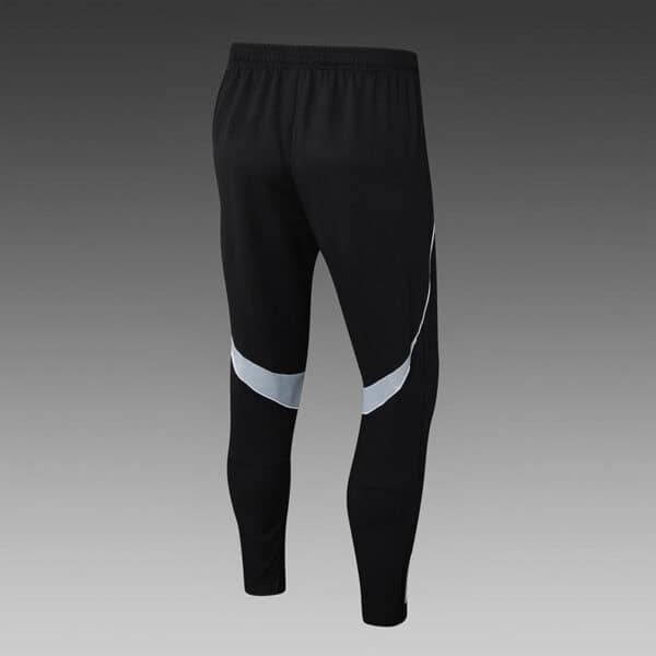 Black Adidas tracksuit pants with white accents, athletic fit, perfect for sports and casual wear.