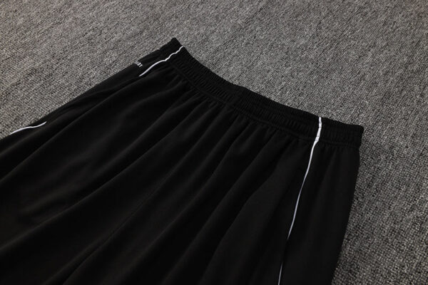 Adidas white tracksuit pants with black accents, comfortable fit, perfect for sports and casual wear.