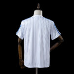 Classic white football jersey with blue pinstripes, vintage design, perfect for sports fans.