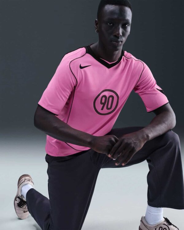 Nike Total 90 pink soccer jersey for men, lightweight and breathable sportswear.