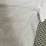 Breathable white sports jersey fabric with textured pattern, ideal for athletic and team sports appa.
