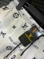 Louis Vuitton white swim shorts with iconic monogram print, comfortable fit, perfect for beach or po.