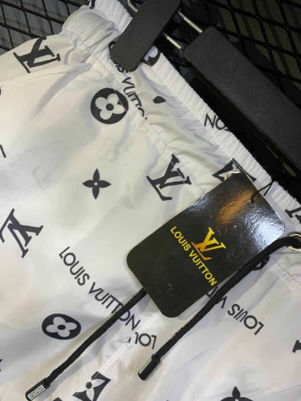 Louis Vuitton white swim shorts with iconic monogram print, comfortable fit, perfect for beach or po.
