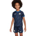 Child wearing Chelsea FC away kit 2023/24, navy blue with team logo and Nike branding.