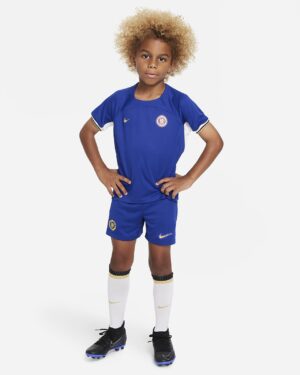 Kids home kit 2023/24 Chelsea FC, authentic blue football jersey and shorts for young fans.