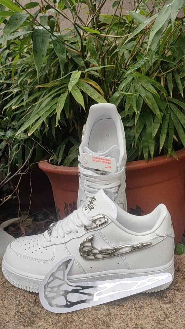 Air Force Low 1 ‘Molten Metal’ sneaker with metallic swoosh and white sole.