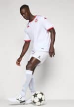 Football jersey with red accents and white shorts, soccer player in action.