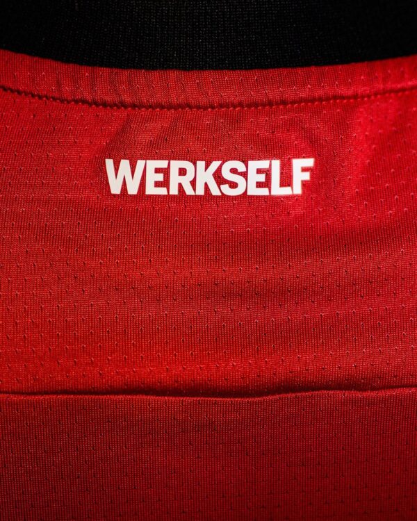 Bayer Leverkusen 2024/25 home football jersey with WERKSELF logo, red color, and breathable fabric.