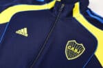 Official Boca Juniors football jacket for 2025/26 season, navy blue with yellow accents and club cre.
