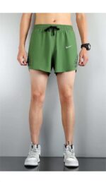 Nike Pro Dri-FIT athletic shorts in green and black.