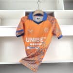 Official Rangers FC third football jersey 2024/25 season. Bright orange with blue accents and team l.