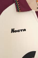 Close-up of Nocta branded football jersey, high-quality sportswear for soccer enthusiasts.