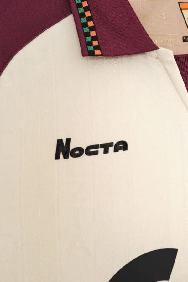 Close-up of Nocta branded football jersey, high-quality sportswear for soccer enthusiasts.