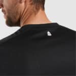 Black sports jersey with small logo on back neck, ideal for football training and matches.