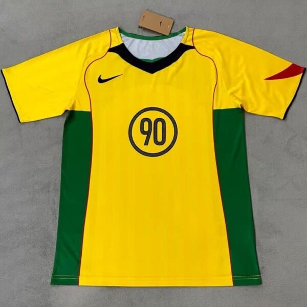 Nike Total 90 yellow soccer jersey with black and red accents, featuring the number 90 on the front.