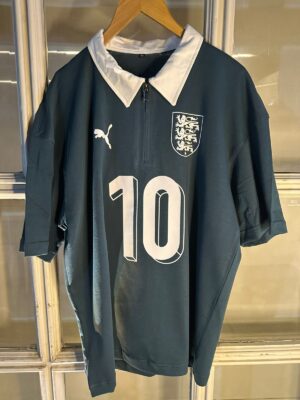 England football team official black polo with white collar and crest.