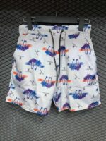 Bright white swim shorts with colorful palm tree and sunset print, perfect for summer beach days.