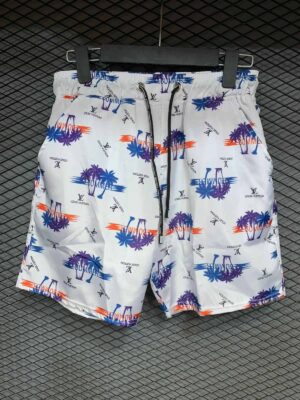 Bright white swim shorts with colorful palm tree and sunset print, perfect for summer beach days.