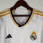 Authentic Real Madrid white football jersey with gold accents and club crest.
