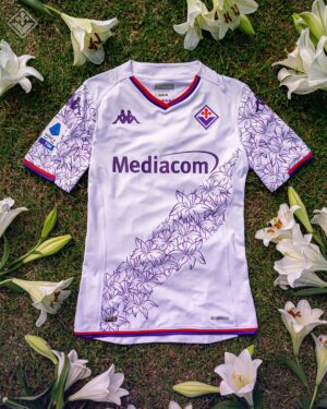 Fiorentina away football jersey 2023/24 with purple floral design and Mediacom sponsor.