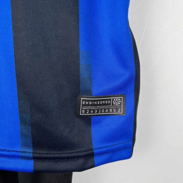Inter Milan youth home kit 2023/24 with official team badge and design.