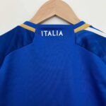 Official Italy youth football jersey for 2023/24 season, featuring blue color and "ITALIA" text on t.