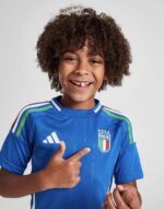 Italy youth home football kit 2024/25 with team crest and vibrant blue design.
