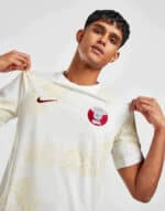 Qatar away football jersey 2024 with team crest and Nike logo, lightweight and breathable for match.