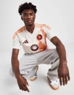 UAE football jersey with team logo and stylish sneakers for sports fans.