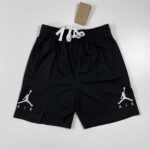 Black Jordan basketball shorts with white Jumpman logo, adjustable drawstring waist, breathable fabr.