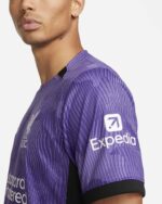 Third jersey football shirt for 2023/24 season, purple with black accents, featuring Expedia logo.