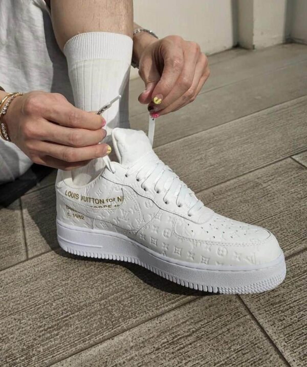 Louis Vuitton x Nike Air Force 1 Low white sneakers with embossed monogram design.