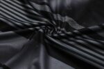 Authentic Manchester City training jersey fabric with black and gray design.