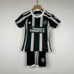 Kids Manchester United away football kit 2023/24, black and white design.