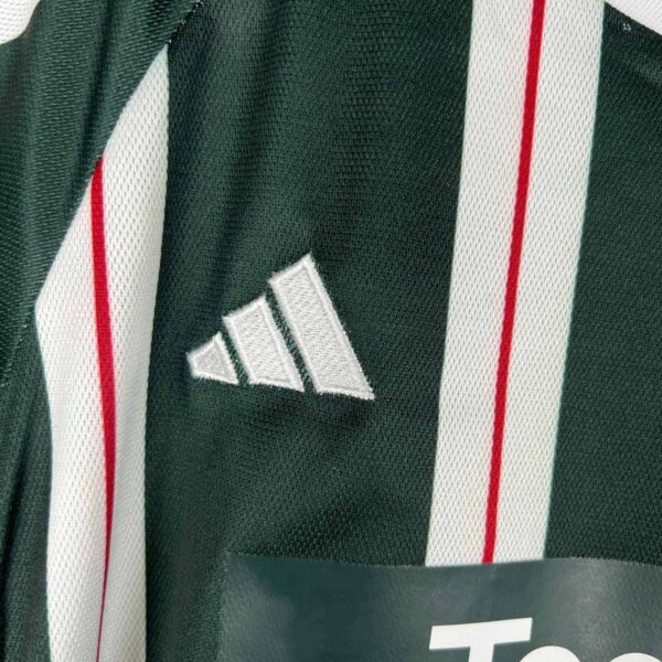 Kids Manchester United away football kit 2023/24 with team logo and design details.