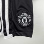 Manchester United kids away kit 2023/24 with club badge detail.