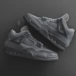 Air Jordan 4 'Wet Cement' in all-black design with premium materials.