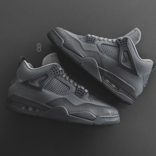 Air Jordan 4 'Wet Cement' in all-black design with premium materials.