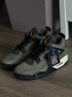 Air Jordan 4 Retro "UNDEFEATED" olive green and black basketball shoes with orange accents.