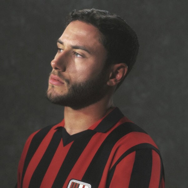 Men's football jersey with red and black stripes, perfect for sports fans and players.