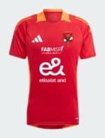 Red Al Ahly training jersey with team crest and sponsor logos, perfect for fans and players.