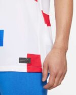 Close-up of NetherLan 2022 Stadium Away football jersey with red and white design.