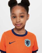 Official Netherlands youth football jersey 2024, orange with blue accents, featuring lion crest and.